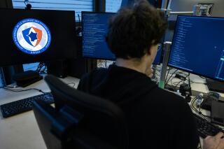 An agent of the operational center of the French National Cybersecurity Agency (ANSSI) checks datas on a computer in Paris on November 24, 2022. (Photo by Thomas SAMSON / AFP)